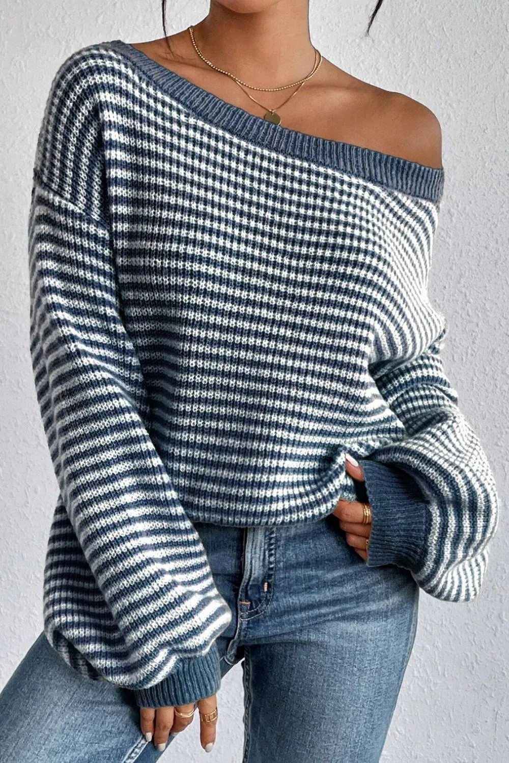 Blue and white striped boat-neck long sleeve sweater with wide ribbed cuffs