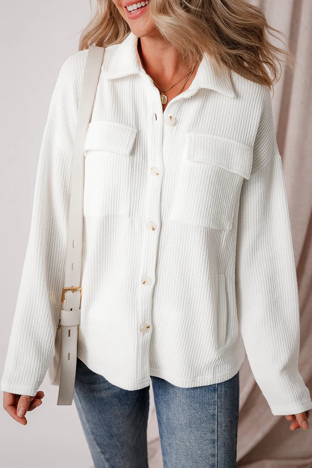 White long-sleeve shacket with button front and two chest pockets.