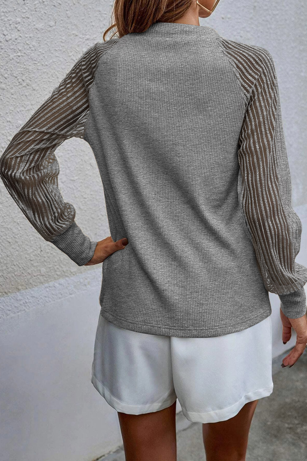 Charcoal raglan knit top with round neck and vertical striped sleeves (back)