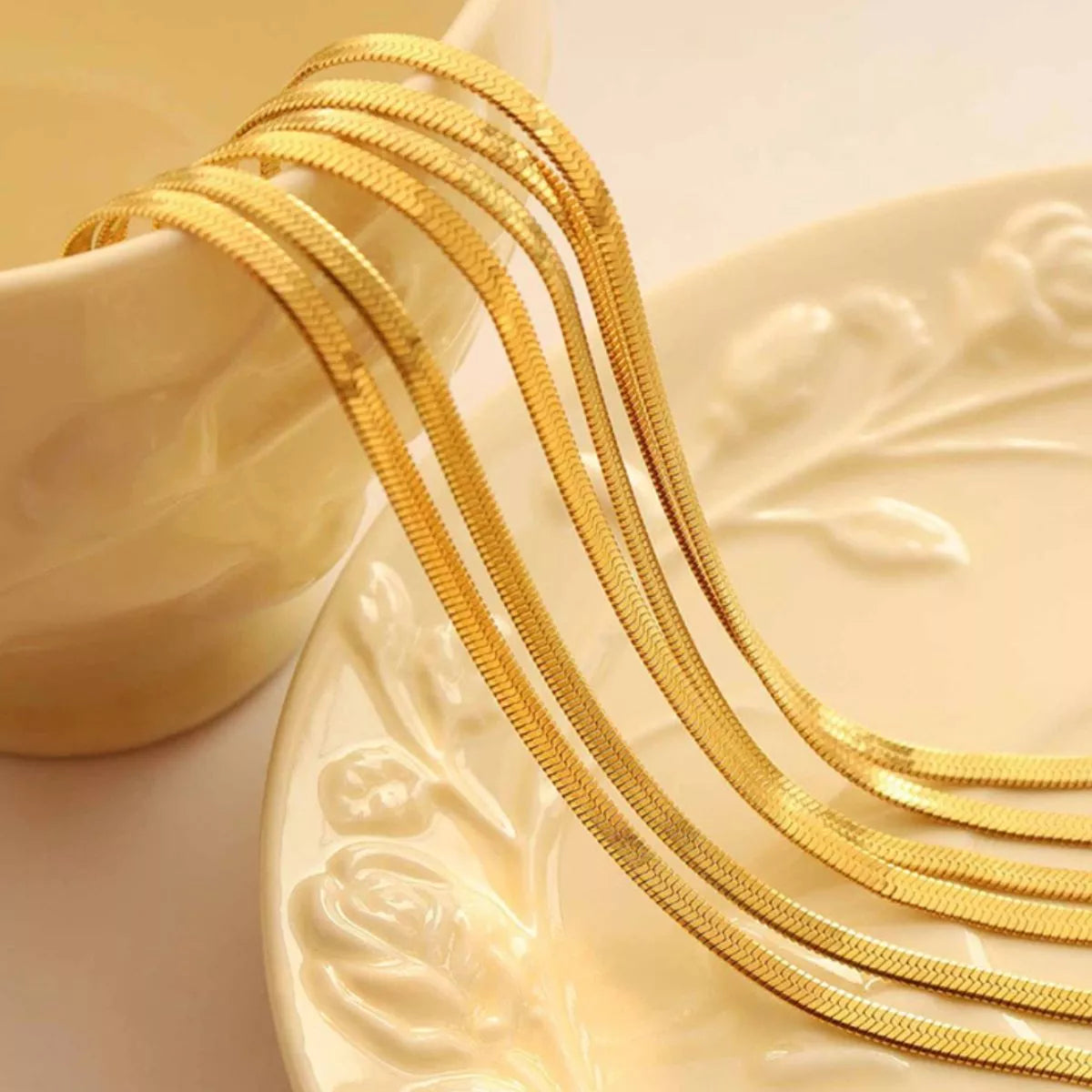 Gold-plated multi-strand chain necklace, close-up of braided texture