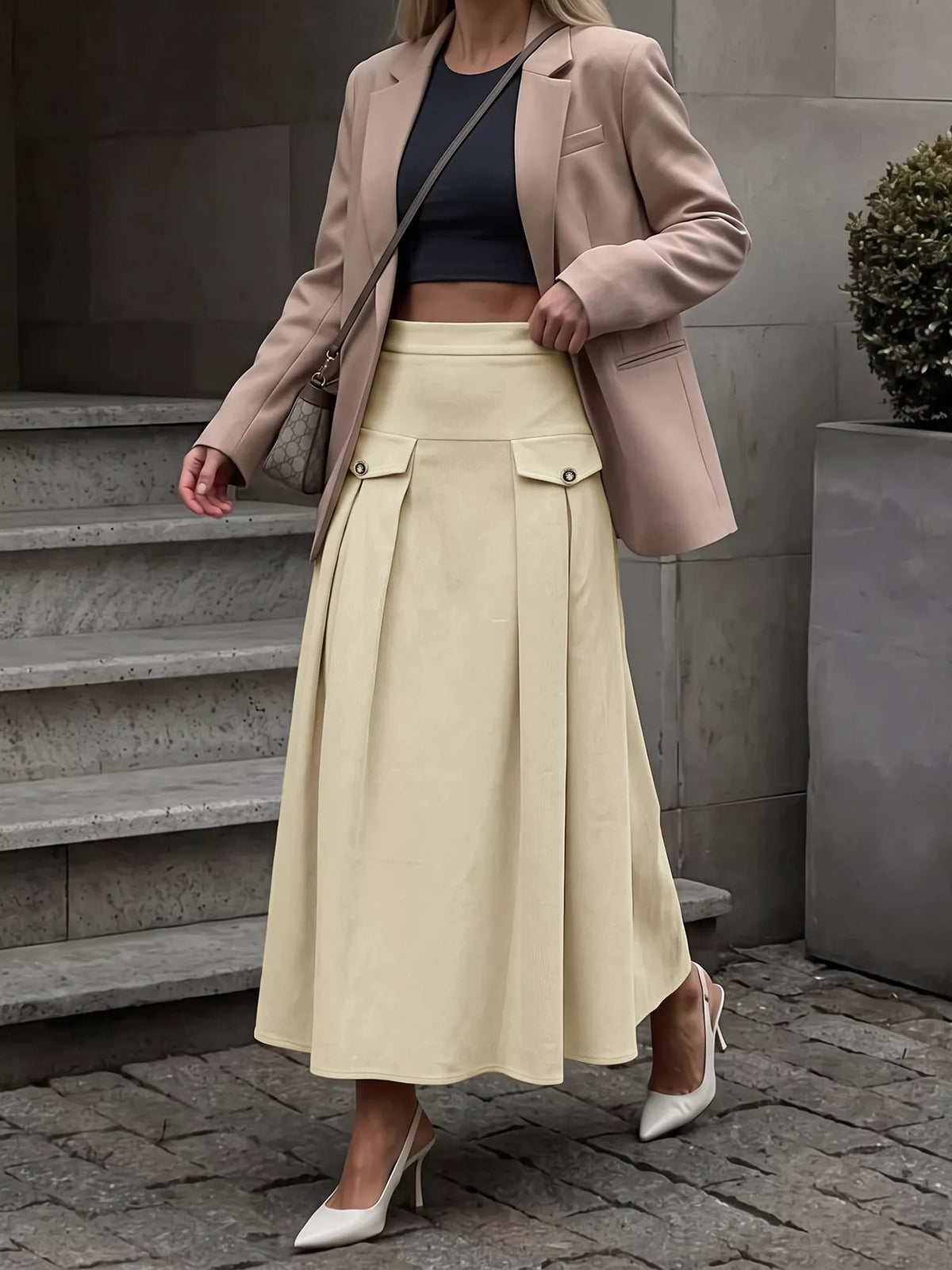Khaki pleated midi skirt with high waist, front zipper, and patch flap pockets