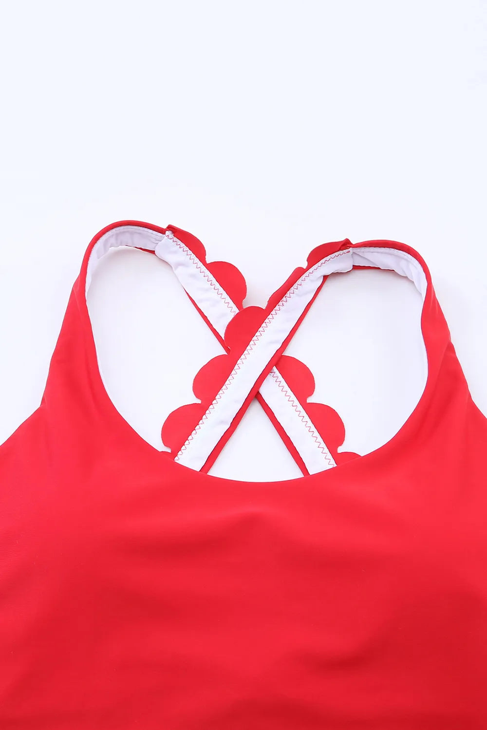 Red crisscross back straps on scoop neck swim top with scalloped hem