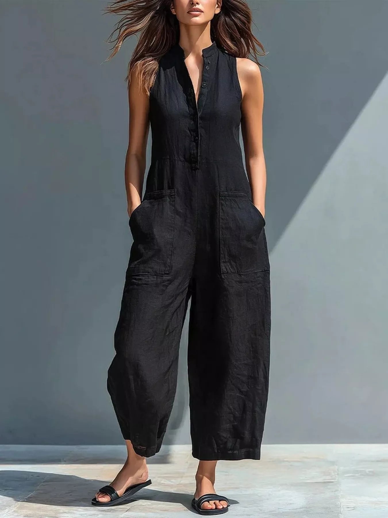 Black sleeveless button-front jumpsuit with patch pockets and wide cropped legs