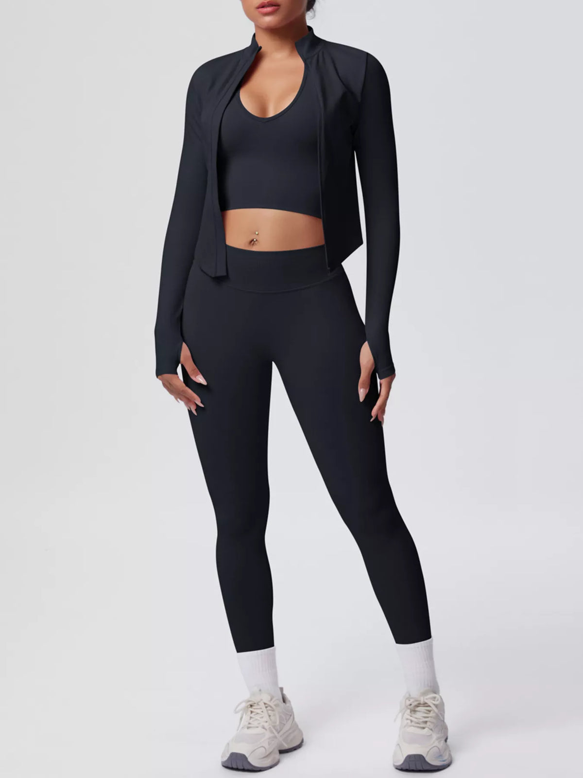 Black seamless workout set: open-front jacket, cropped sports bra, and high-rise leggings.