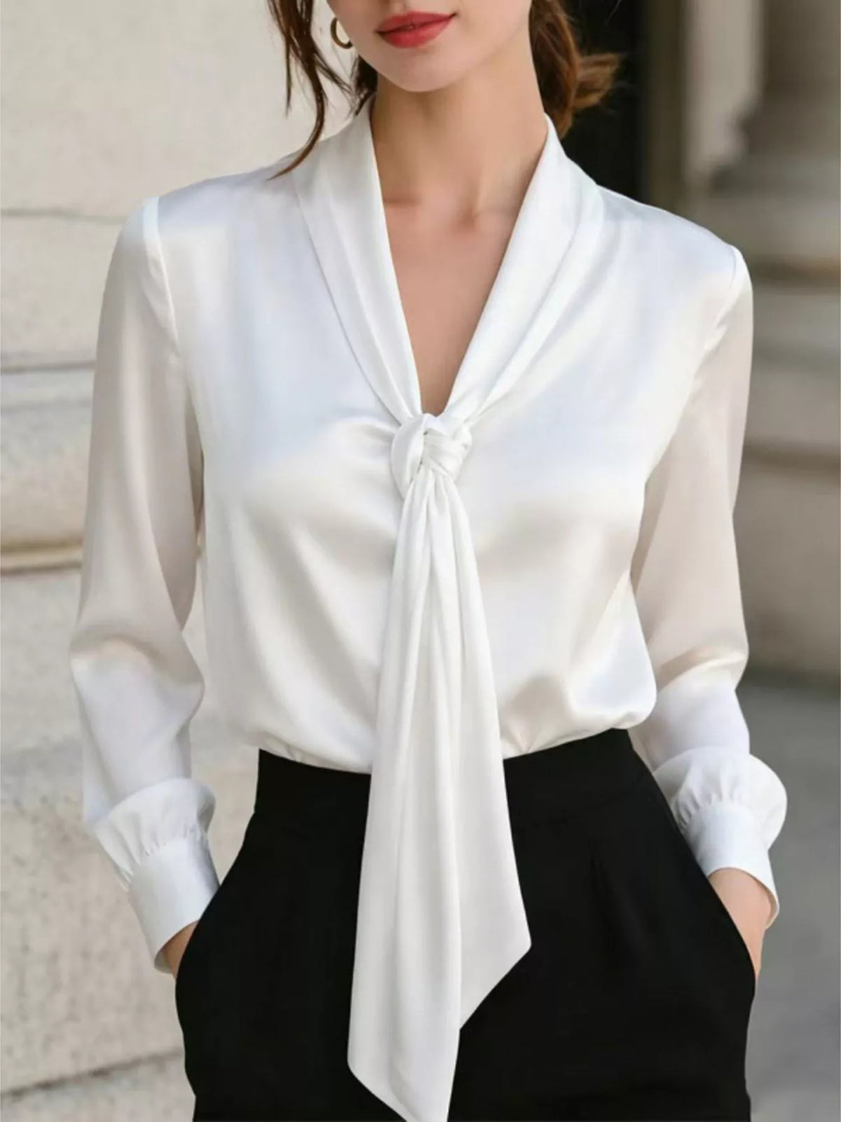 White satin blouse with V-neck and front tie, long puffed cuffs