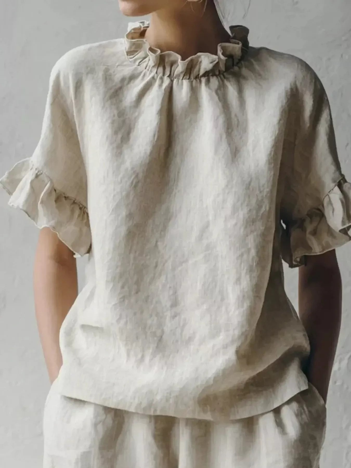 Beige ruffled neck half-sleeve blouse with gathered high neckline and flowy sleeves