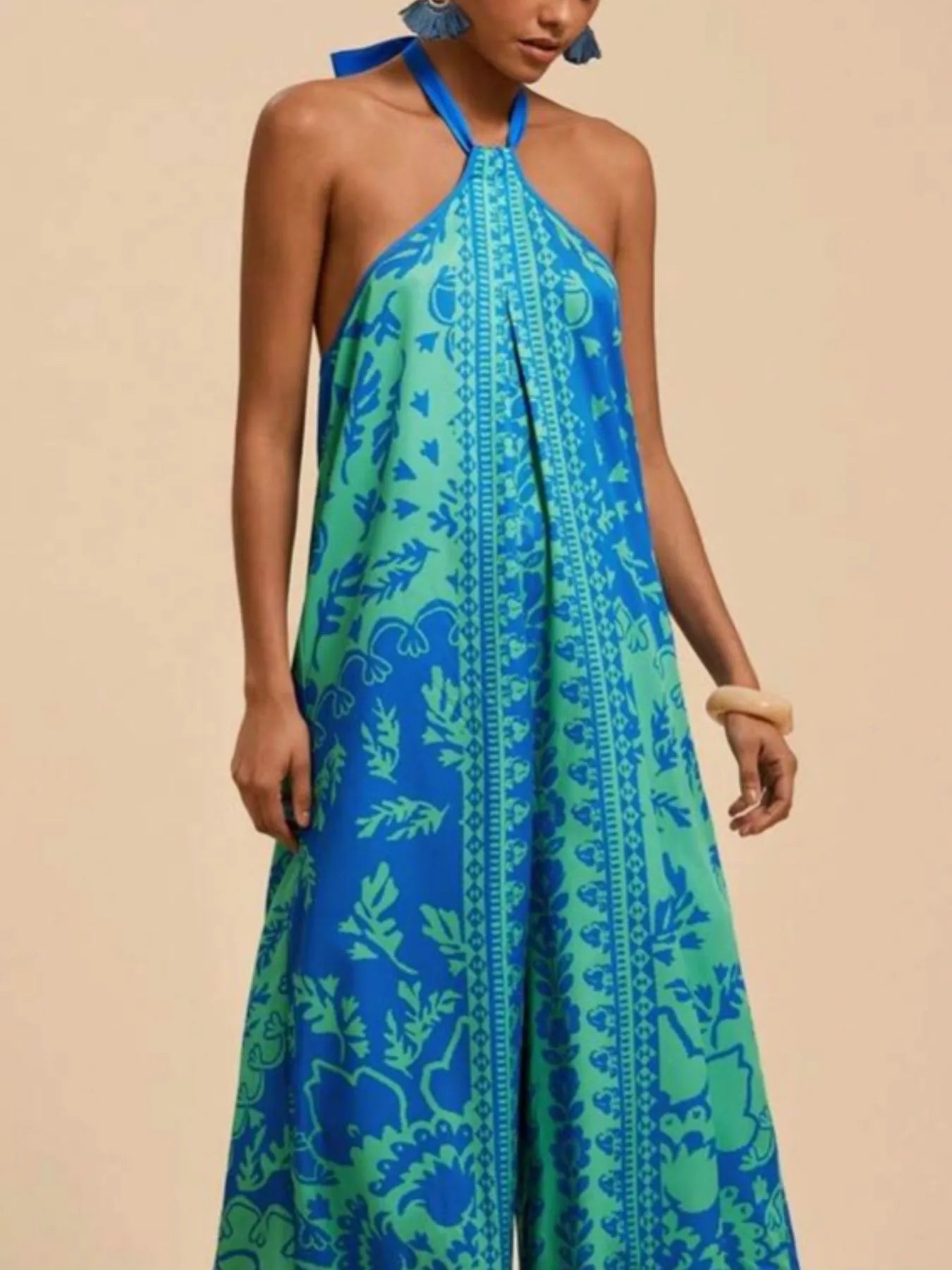 Blue halter wide-leg jumpsuit with leafy print and vertical center seam placket