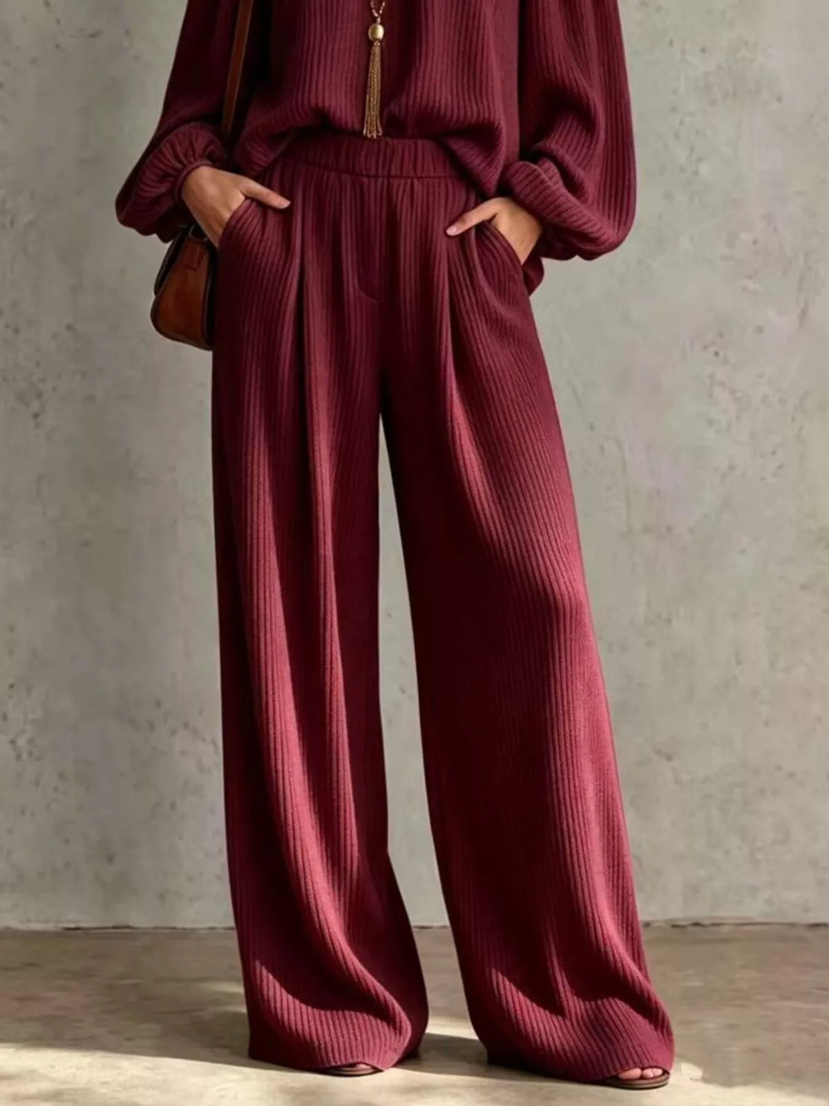 Burgundy ribbed knit wide-leg pants with elastic high waist