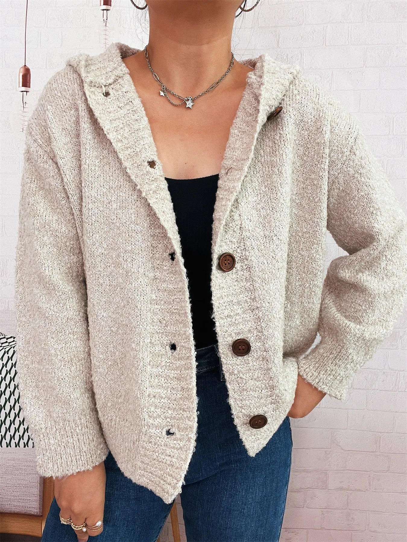 Cozy hooded cardigan, cream textured knit with brown button placket.