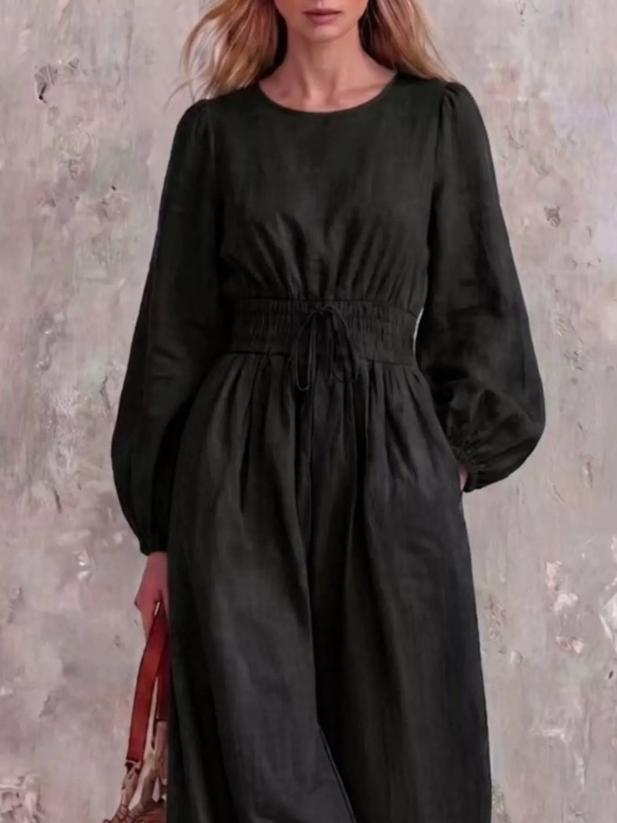 Smocked waist long-sleeve jumpsuit in black, draped skirt and balloon sleeves