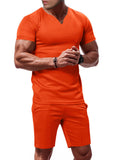 Men's orange V-neck stretch tee and matching shorts set, short sleeves, pull-on fit.