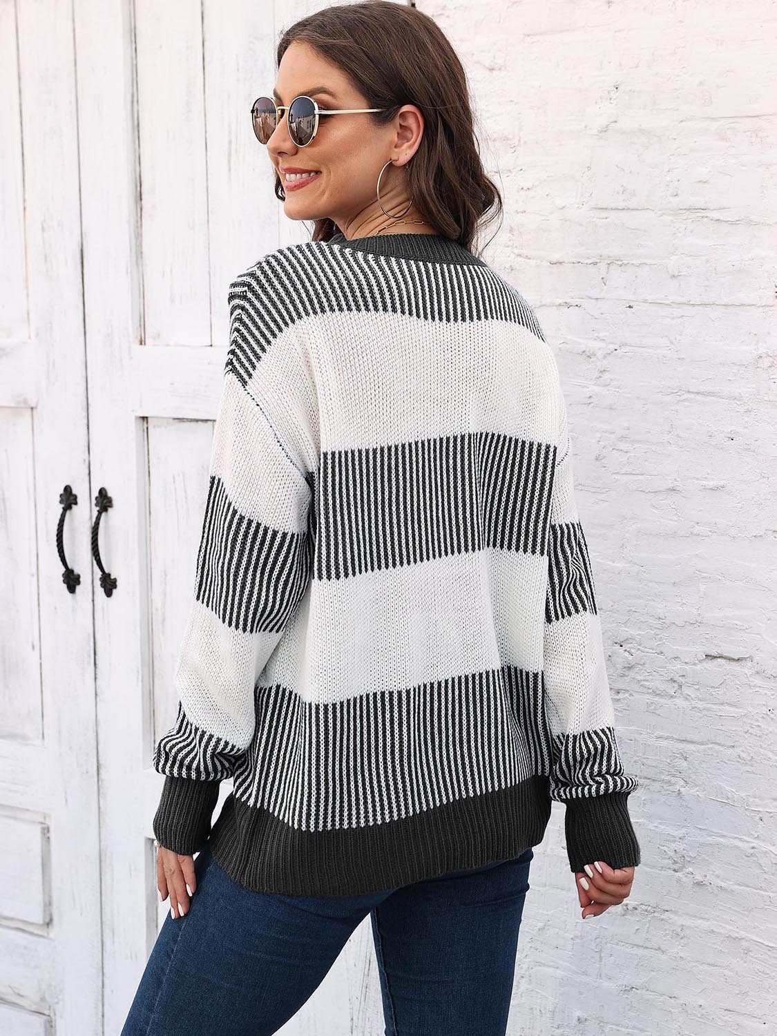 Striped knit sweater back view with round neck, drop-shoulder long sleeves in black and white