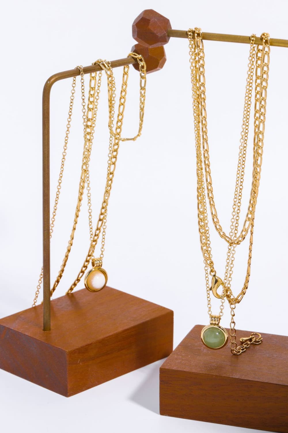 Gold-plated pendant necklace set with round green and white charms on long chains