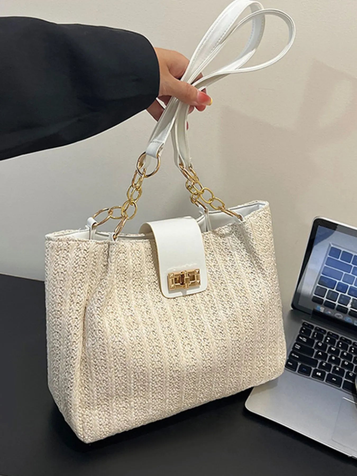 Woven straw shoulder bag with top handle and gold-tone chain straps, beige body