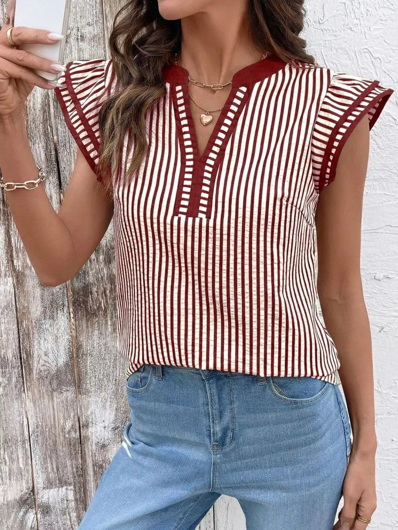 Striped ruffle-sleeve blouse in red and white with burgundy trim and V-neck placket