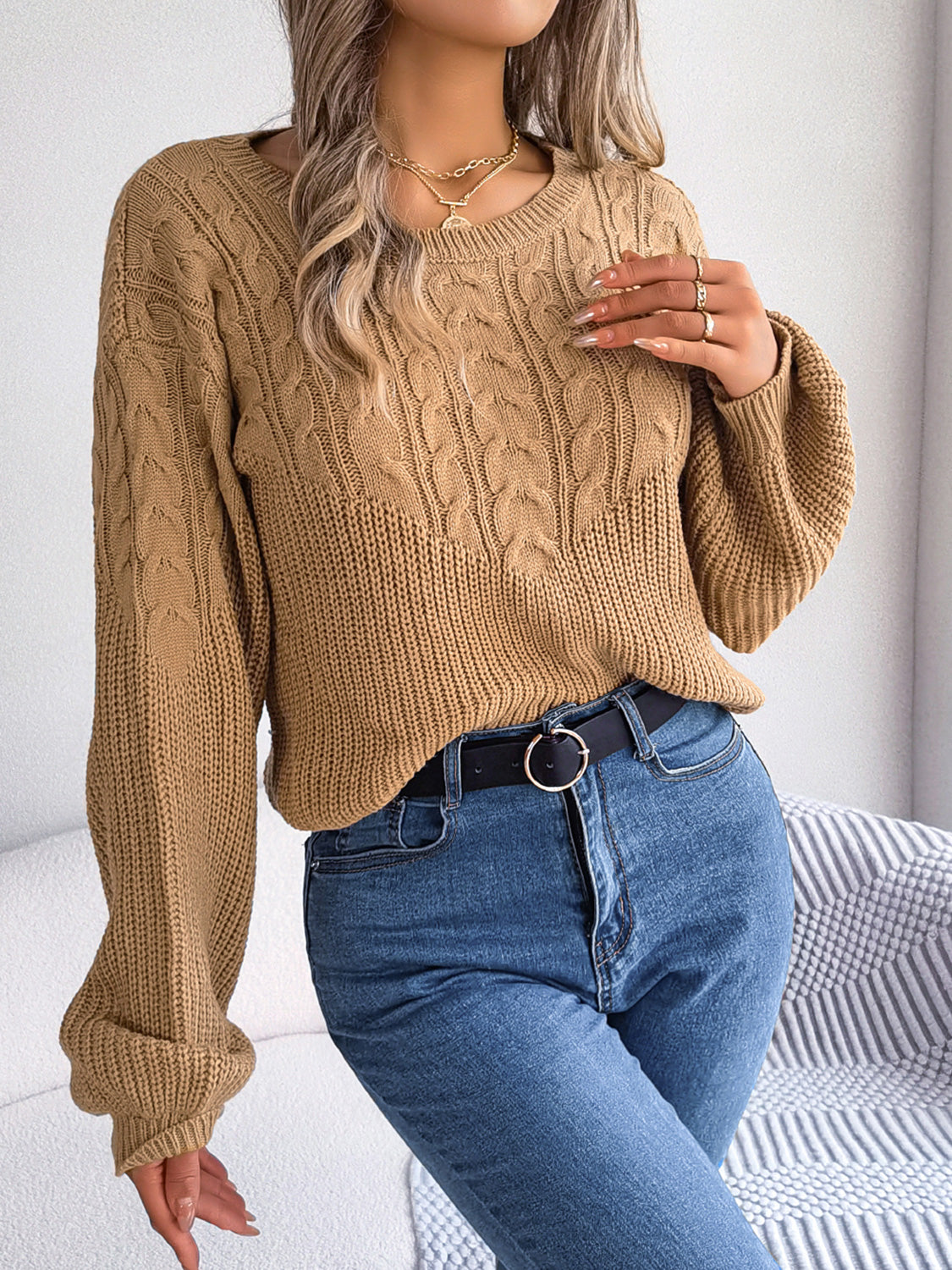 Taupe cable-knit round-neck sweater with drop shoulder and textured cable knit