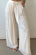 White tie-waist pleated wide-leg pants with gathered elastic waistband and drawstring
