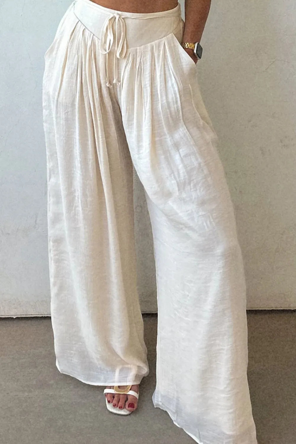 White tie-waist pleated wide-leg pants with gathered elastic waistband and drawstring
