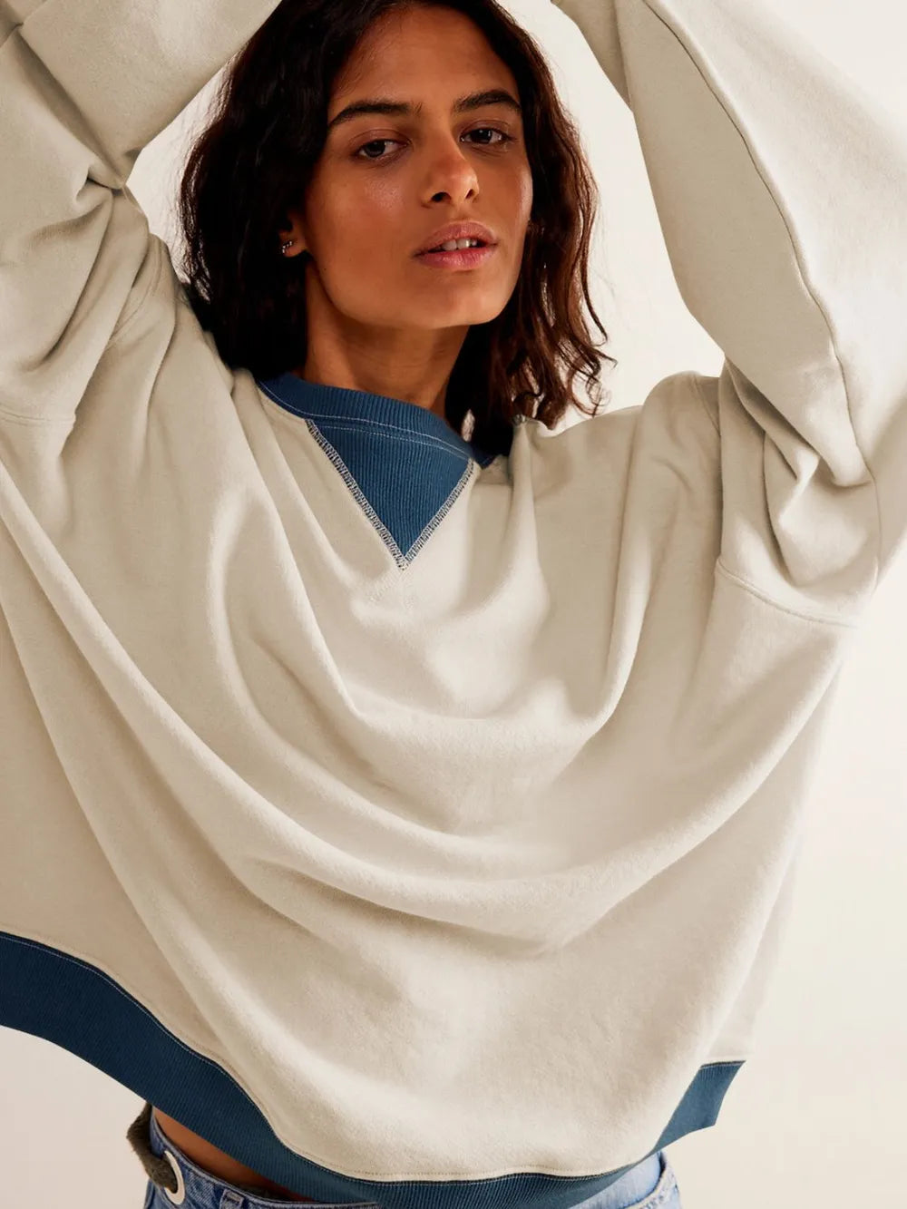 Cream long-sleeve sweatshirt with blue contrast V neckline and blue-trim hem