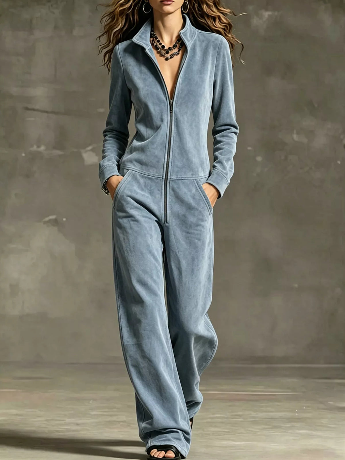 Light blue velour zip-up jumpsuit with front pockets and long sleeves