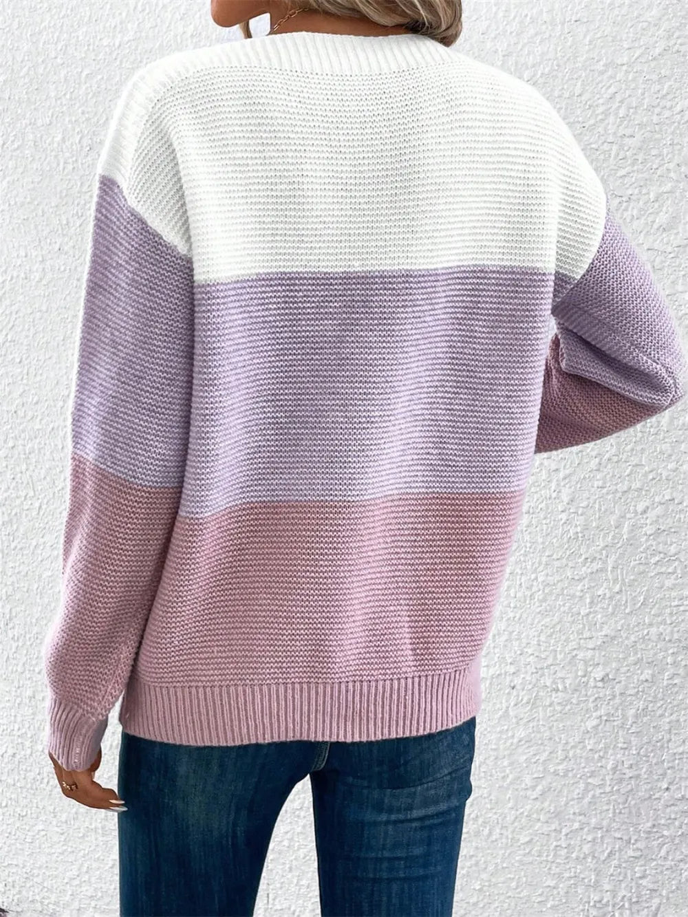 Back view of color-block long sleeve sweater in white and lavender knit stripes