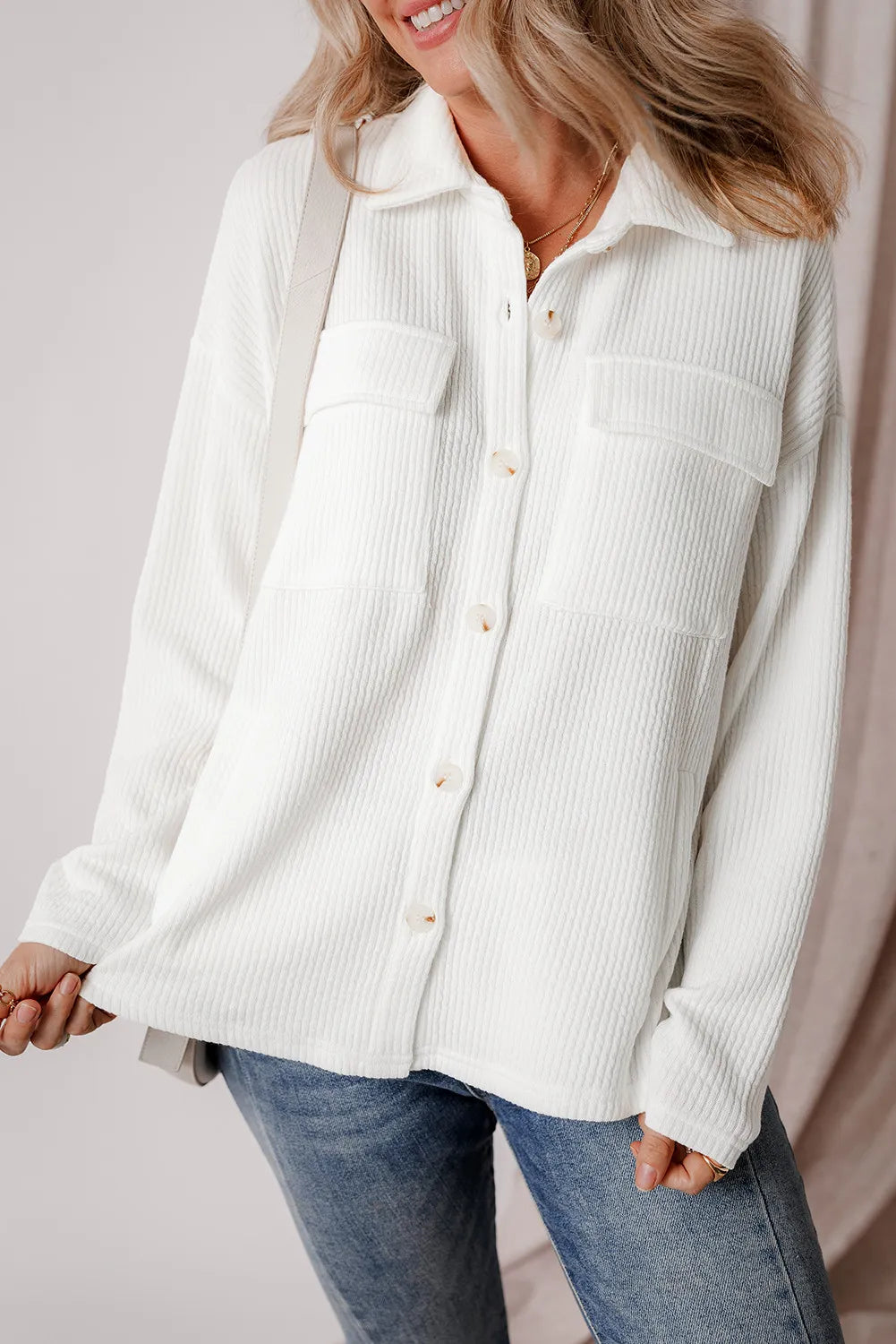 White textured long-sleeve shacket with button front and two flap chest pockets.