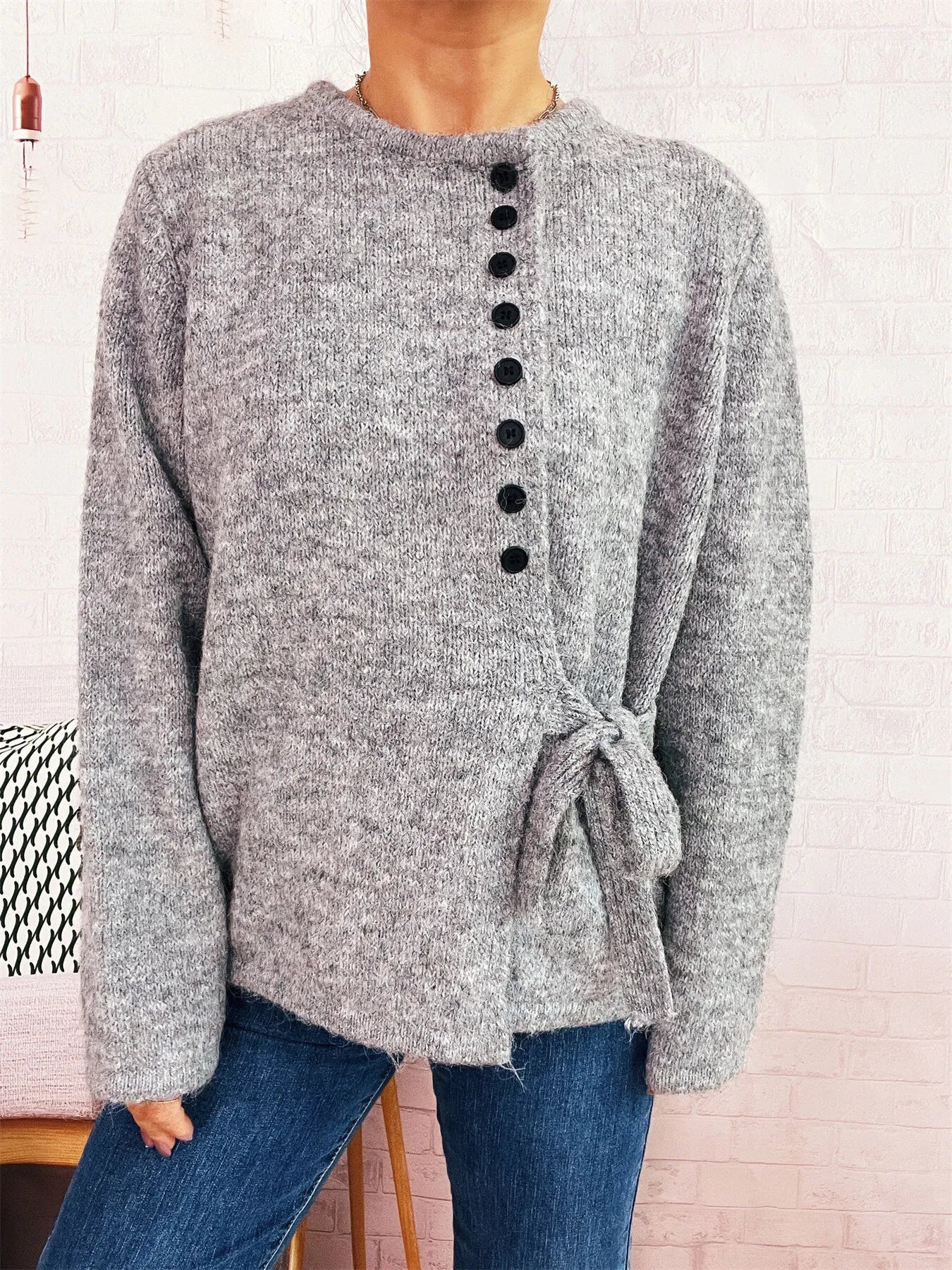 Gray button-front side-tie sweater with long sleeves and black button placket