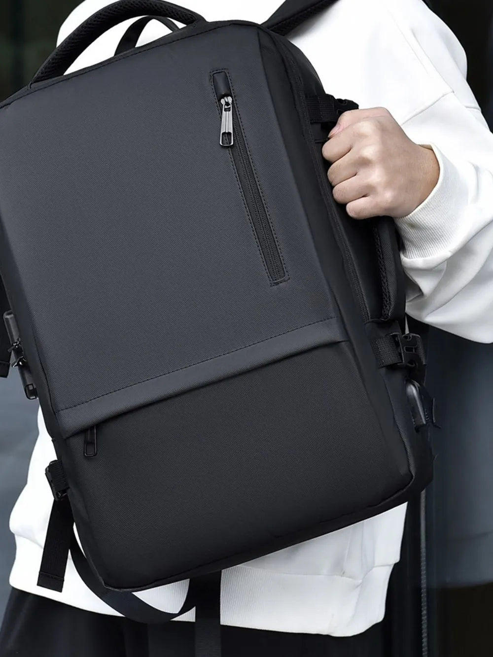 Black backpack with front vertical zipper and side straps