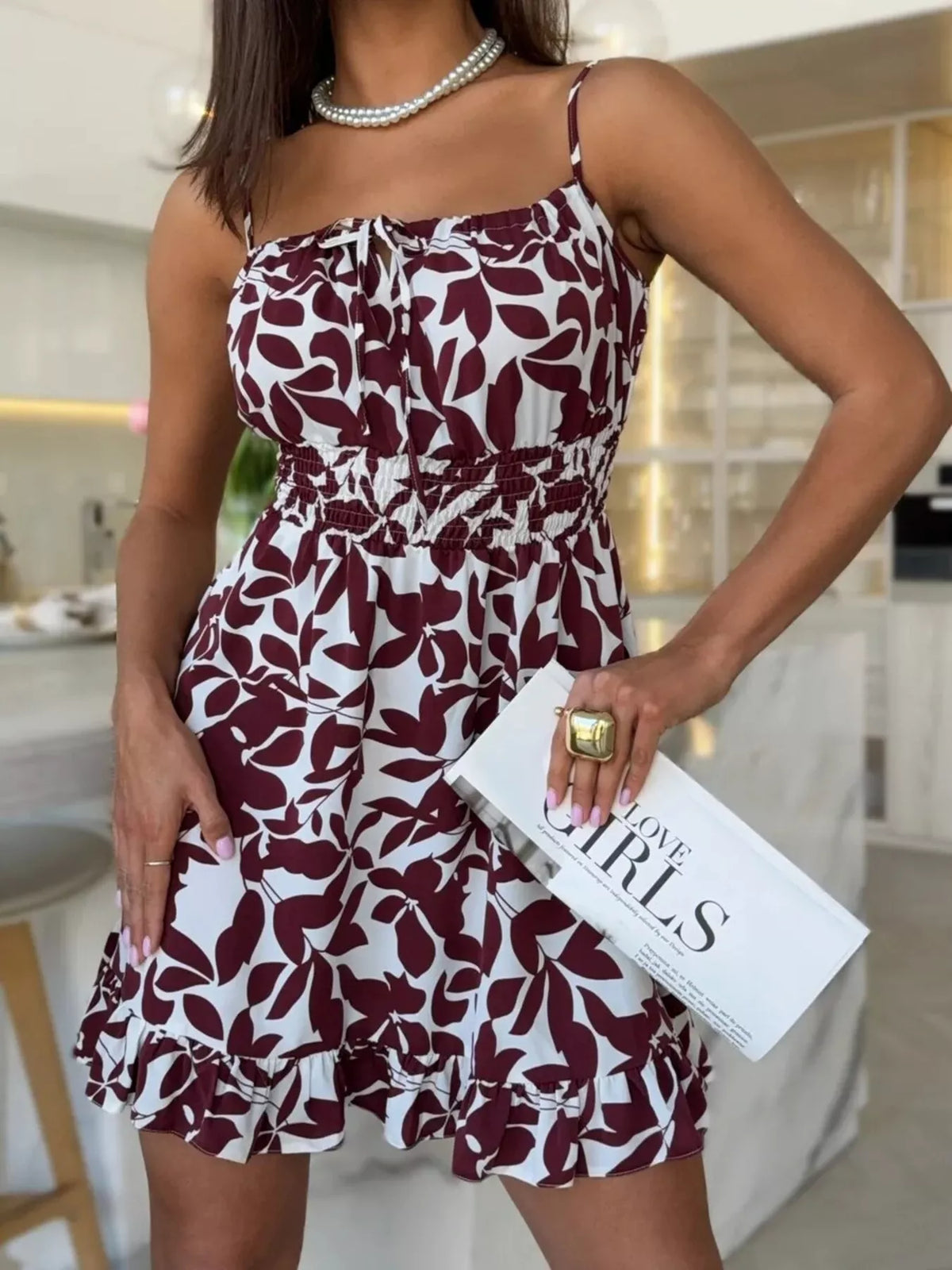 Burgundy mini dress with white abstract print, spaghetti straps, ruffle hem