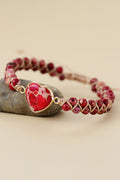 Red beaded heart bracelet with silver-tone heart pendant and adjustable cord ties