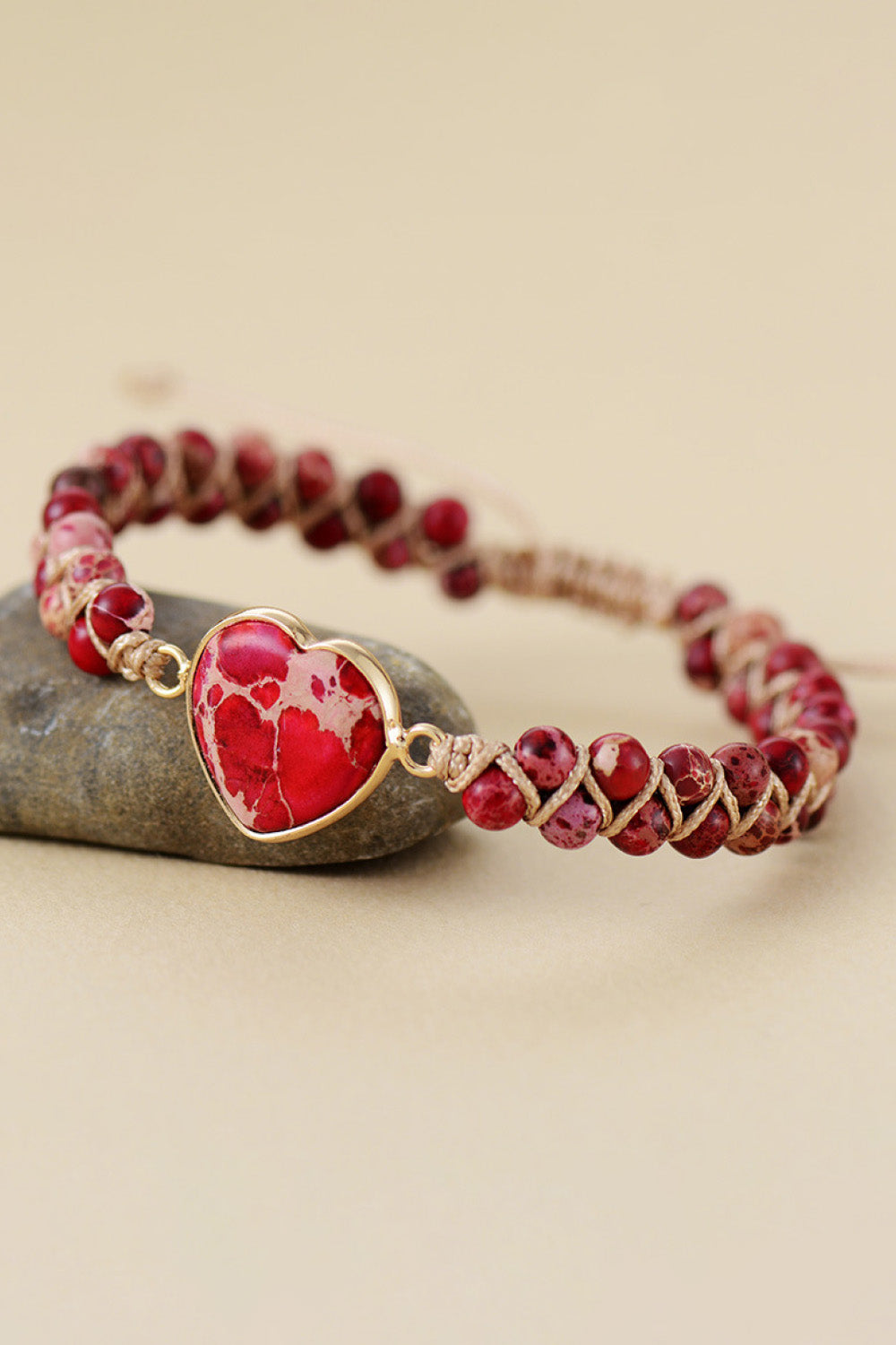 Red beaded heart bracelet with silver-tone heart pendant and adjustable cord ties