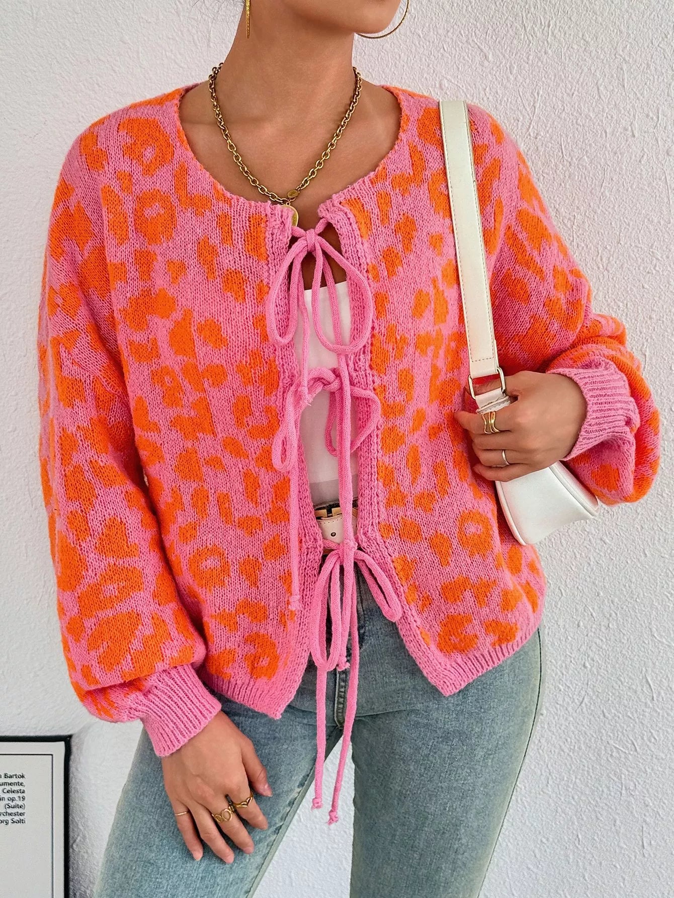 Leopard tie-front cardigan in orange knit with pink drawstring and ribbed cuffs