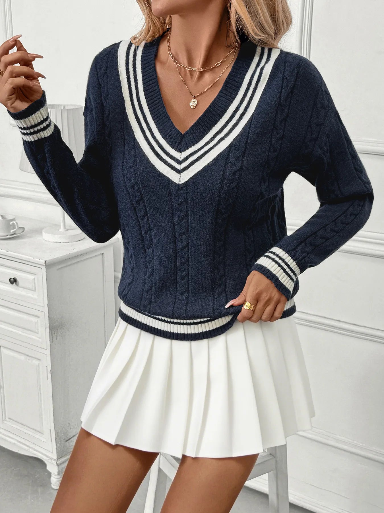 Dark blue V-neck sweater with triple-line contrast stripe collar and hem