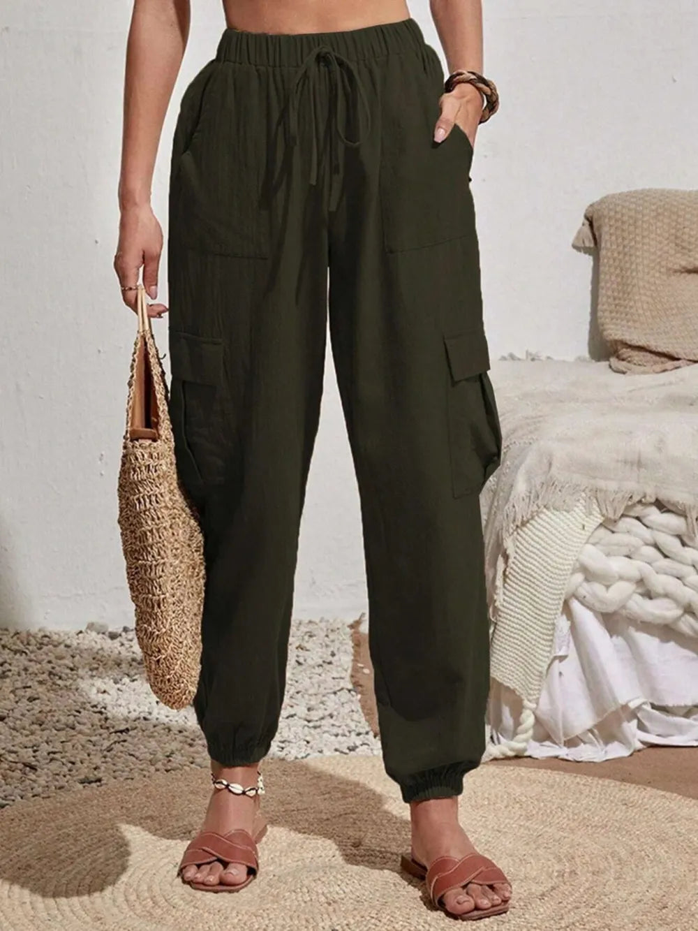 Dark green drawstring cargo joggers with side cargo pockets and elastic cuffs