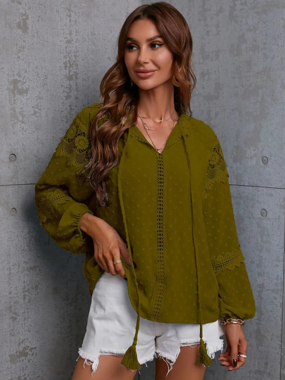 Moss green crochet blouse with tie neck, long sleeves, tassel accents