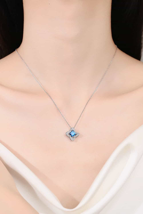 Silver-tone pendant necklace with sky-blue square-cut stone at the center