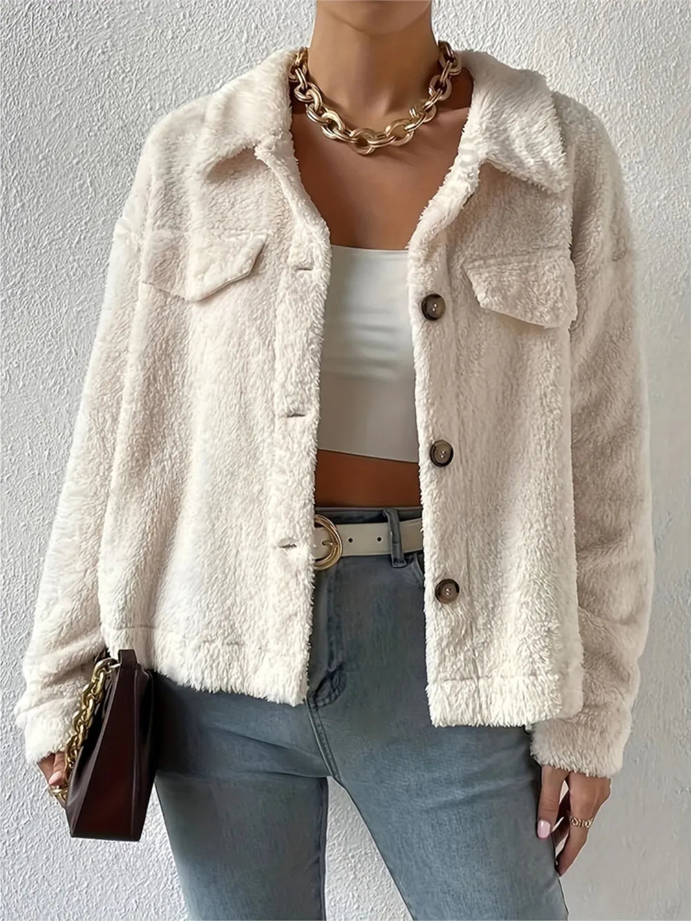 Beige sherpa button-up jacket with collared neckline and flap pockets
