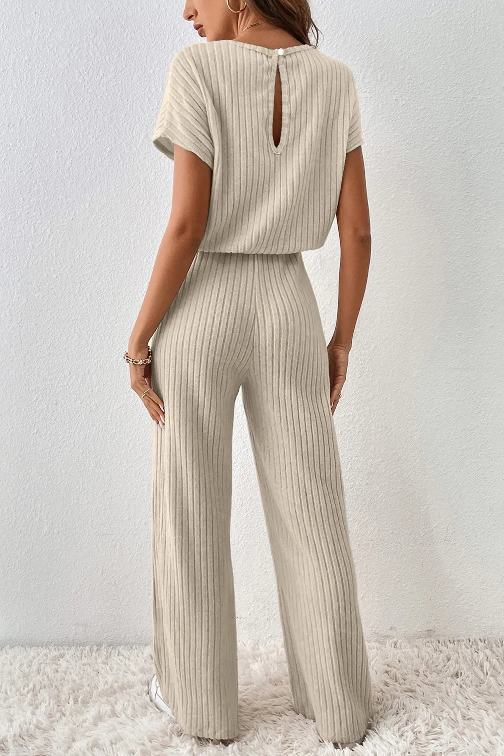 Beige ribbed knit wide-leg jumpsuit with open back keyhole and short sleeves
