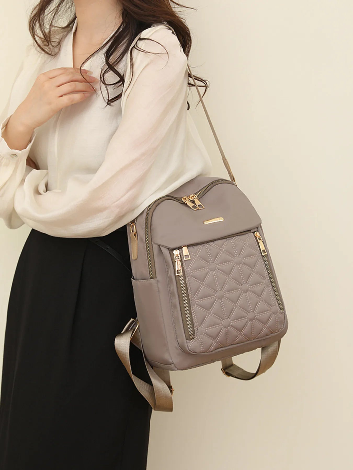 Khaki quilted oxford backpack with front zip pocket, top handle and adjustable strap
