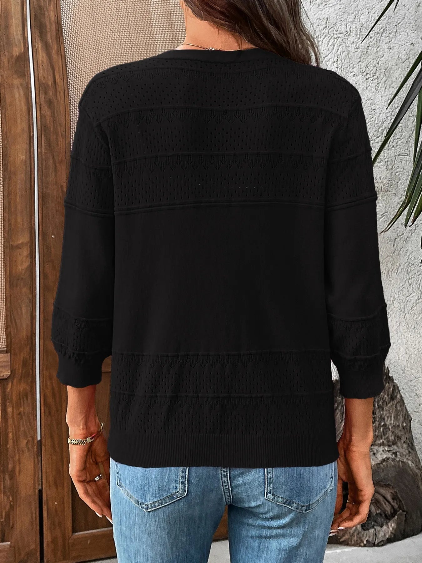 Black textured button-front cardigan, back view with 3/4 sleeves