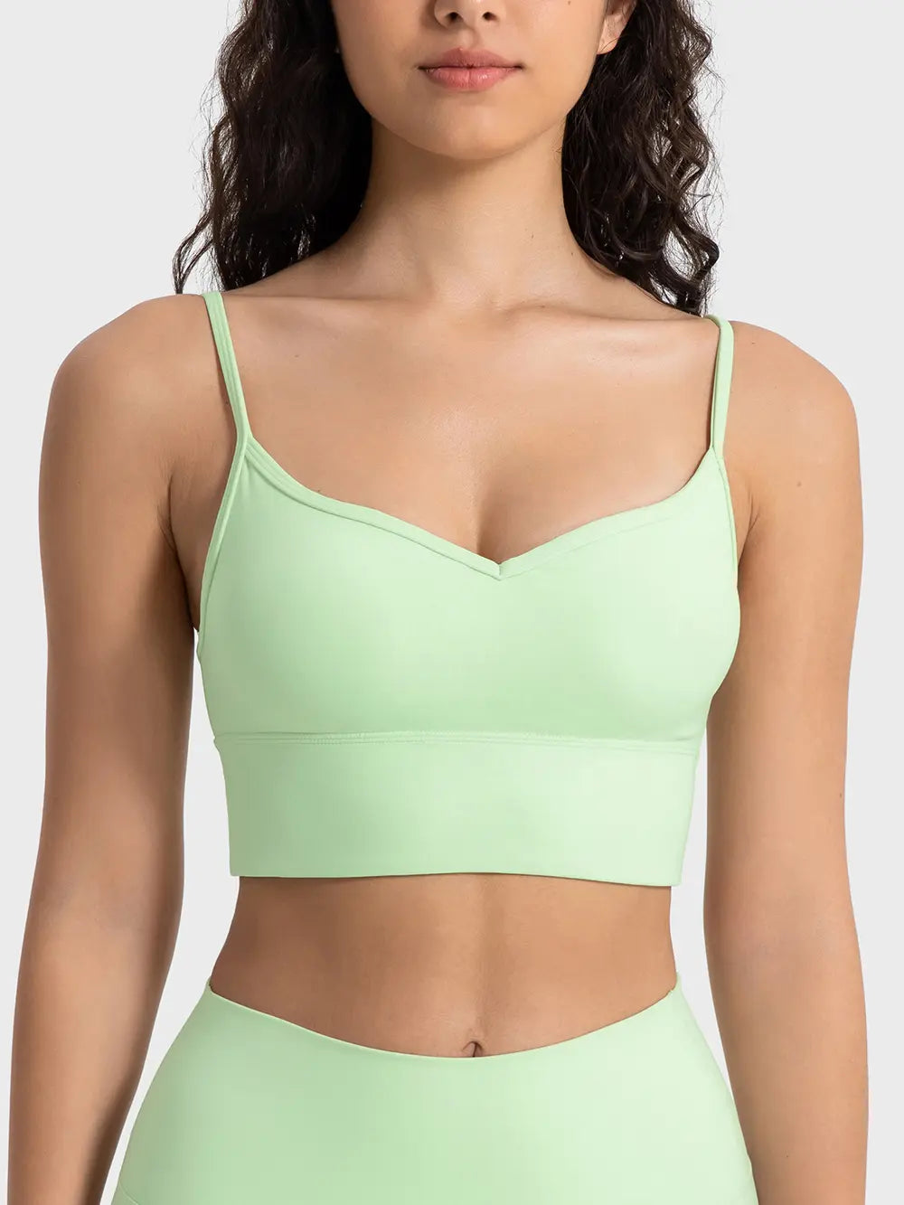 Light green spaghetti strap sport bra with V-neck front