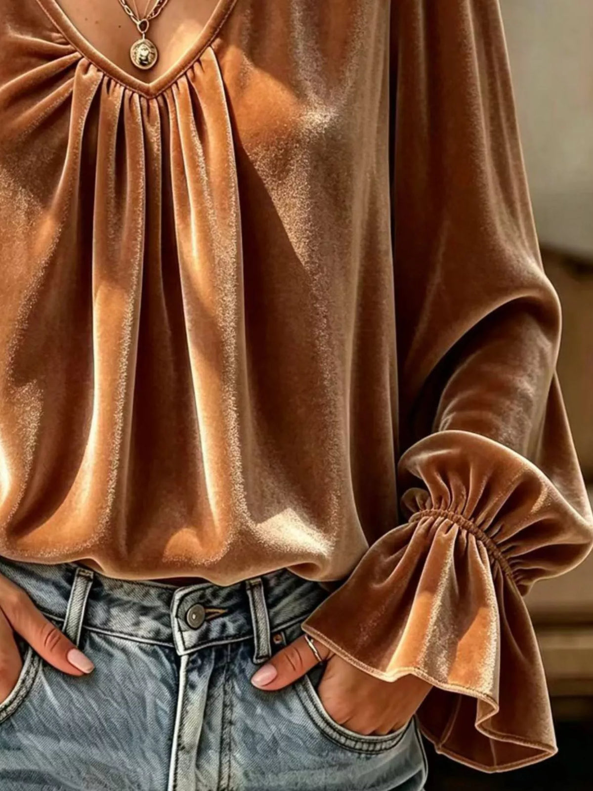 Caramel brown satin blouse close-up with ruched pleats and gathered sleeve cuff