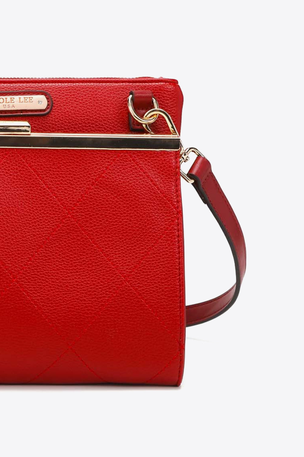 Red quilted handbag side view with crossbody strap and gold tone clasp hardware