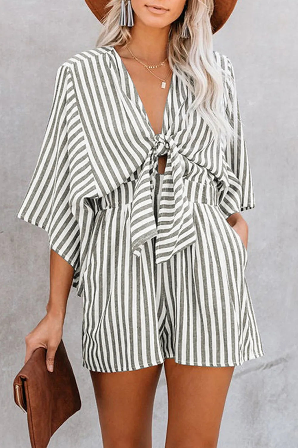 Striped kimono-sleeve romper with V neckline and front tie, ruffle hem and waist, dark stripes