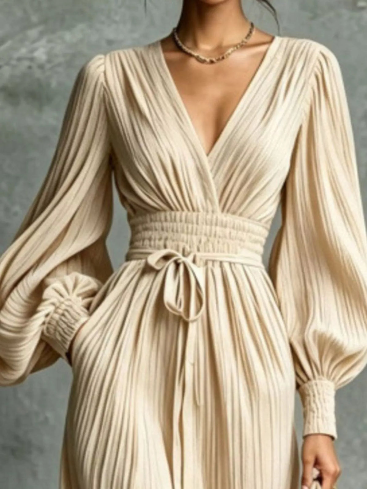 Cream V-neck tie-waist pleated maxi dress close-up with bow at waist