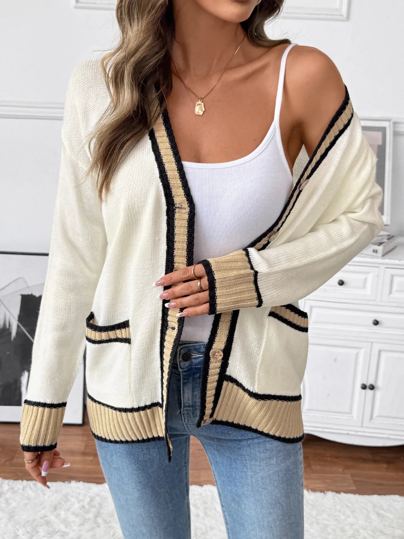 Cream knit cardigan with black and tan contrast trim, button front, long sleeves