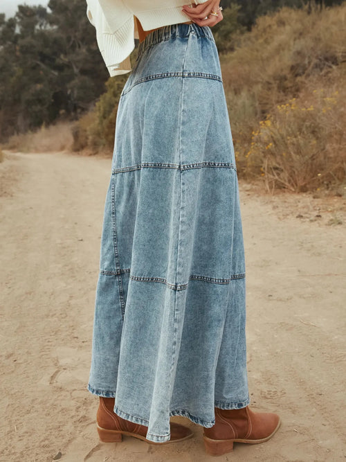 Light blue denim maxi skirt with tiered seams and button-front detail
