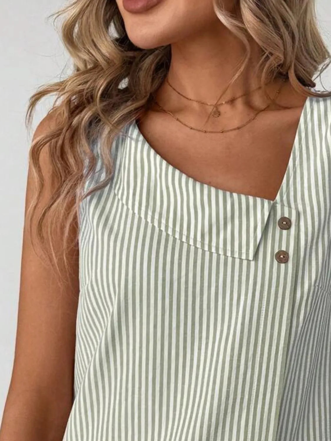 Light blue and white striped tank top with asymmetrical neckline and two-button front