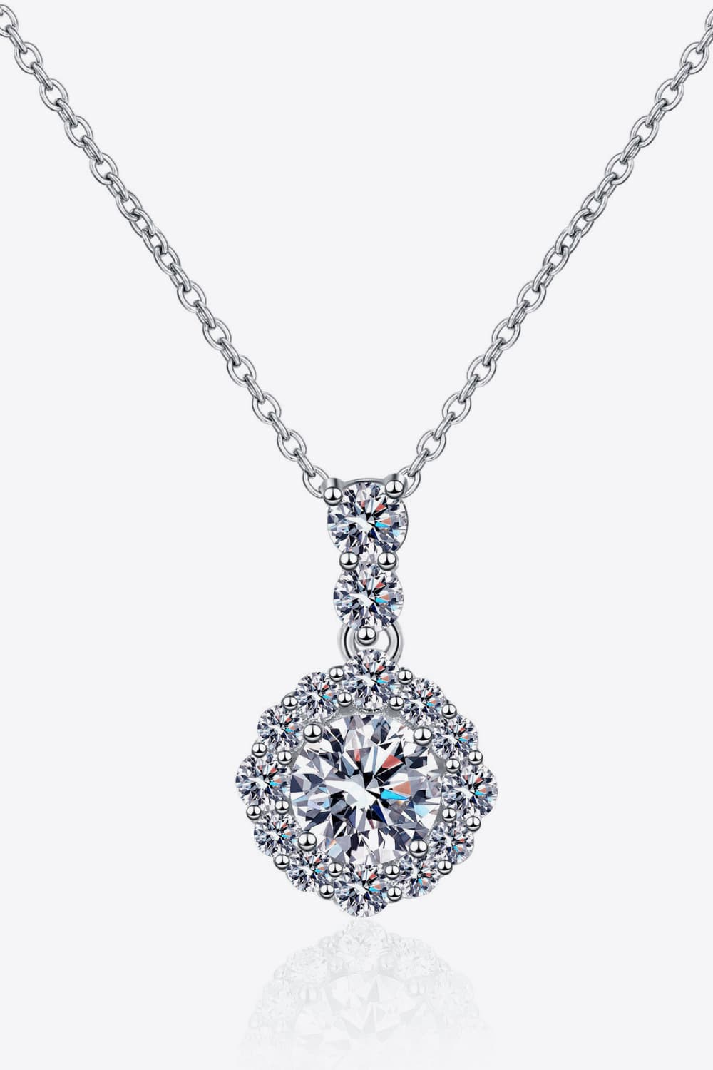Round moissanite pendant necklace in sterling silver, detailed halo and drop design