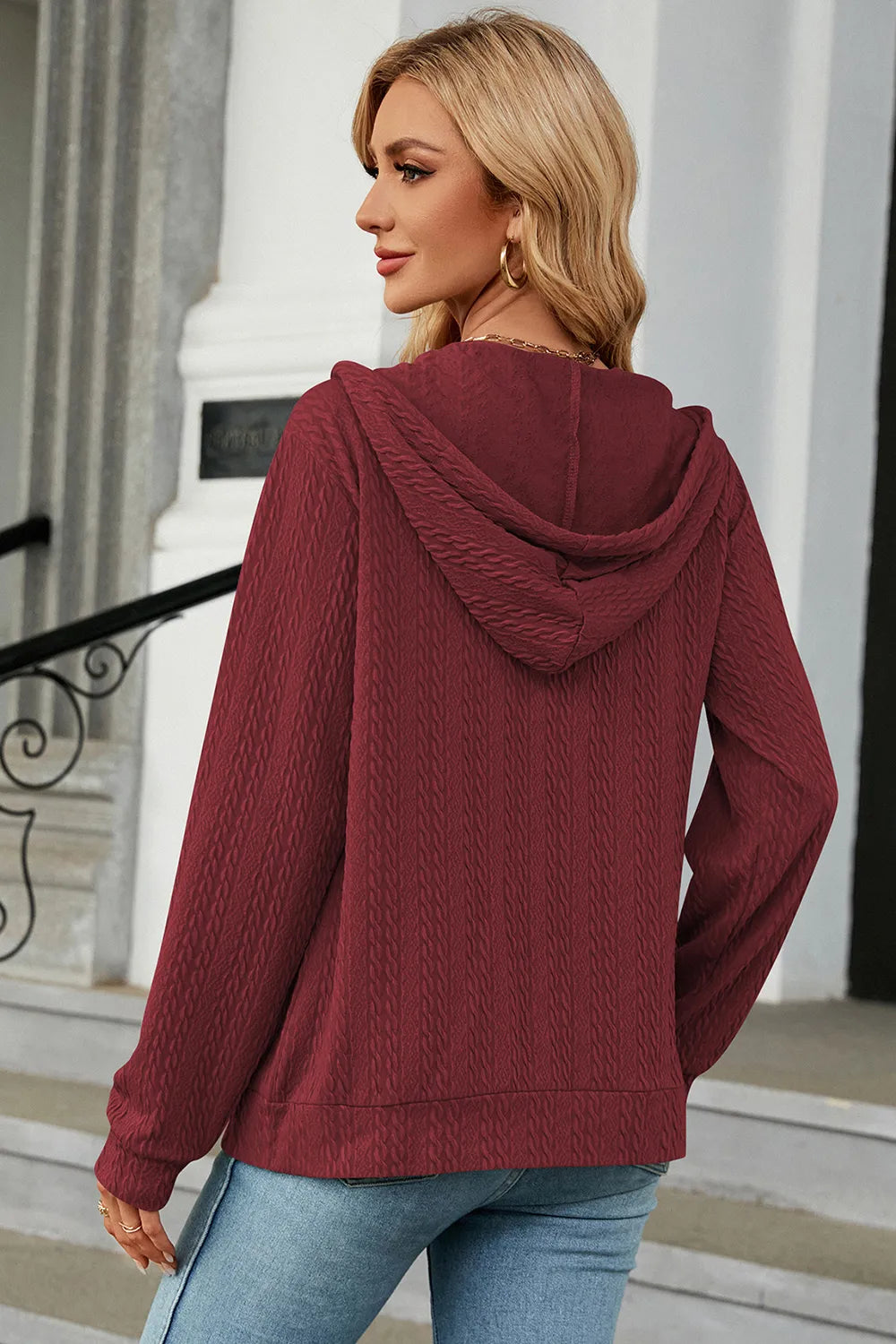 Burgundy zip-up hoodie with drawstring hood, showing back and long sleeves